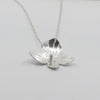 Silver hydrangea pendant on a chain against a light gray background