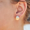 14k gold hand hammered dome stud earrings being worn, super lightweight, handcrafted in Maine USA